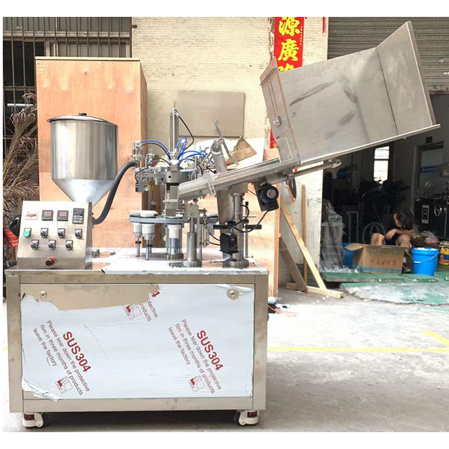 Tube filling and sealing machine